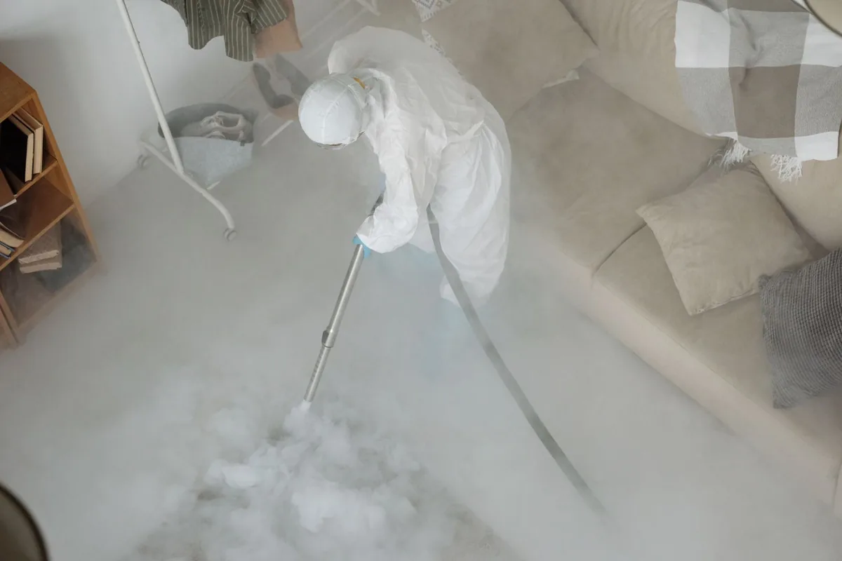 Biohazard cleanup technician in protective equipment, Lawrence, KS